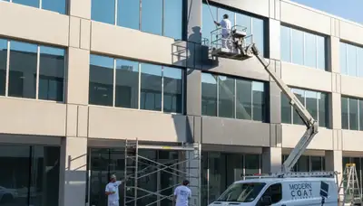 Professional commercial painters in Anaheim, CA applying fresh exterior paint to a business building